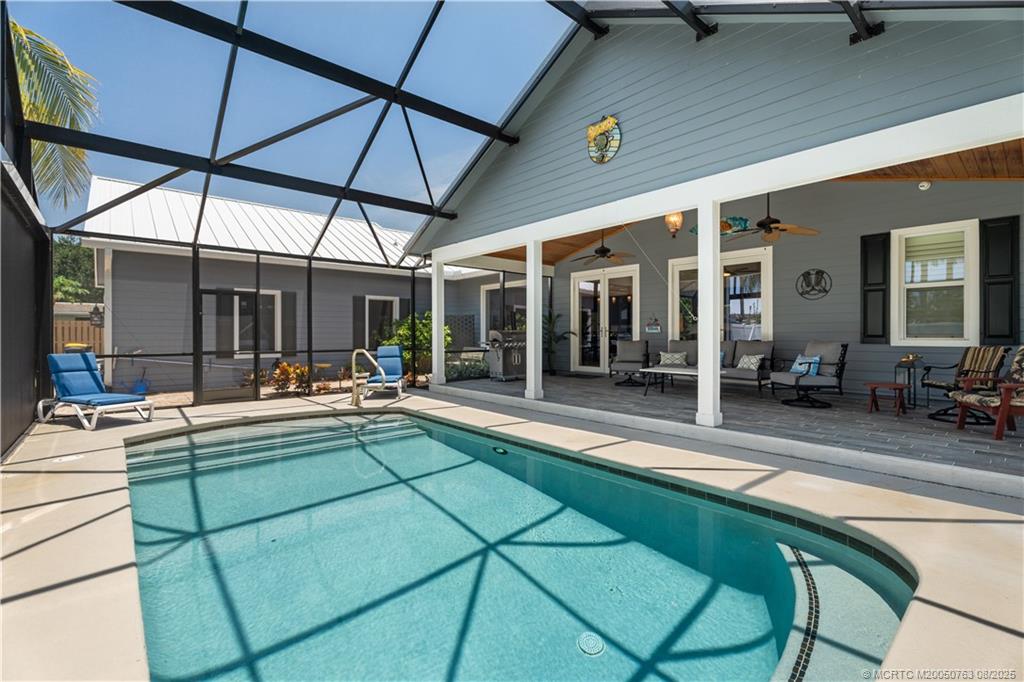 10 Copaire Road Stuart, FL 34996 - Photo 7 of 48 a view of a backyard with a patio and swimming pool