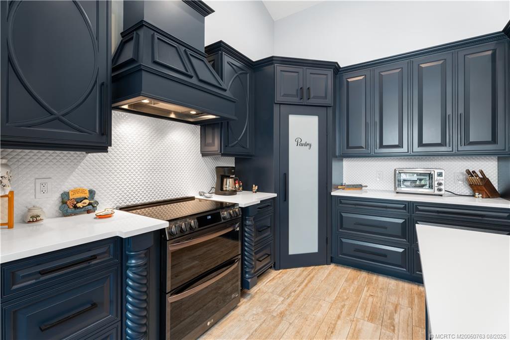 10 Copaire Road Stuart, FL 34996 - Photo 10 of 48 a kitchen with stainless steel appliances granite countertop a stove and a refrigerator