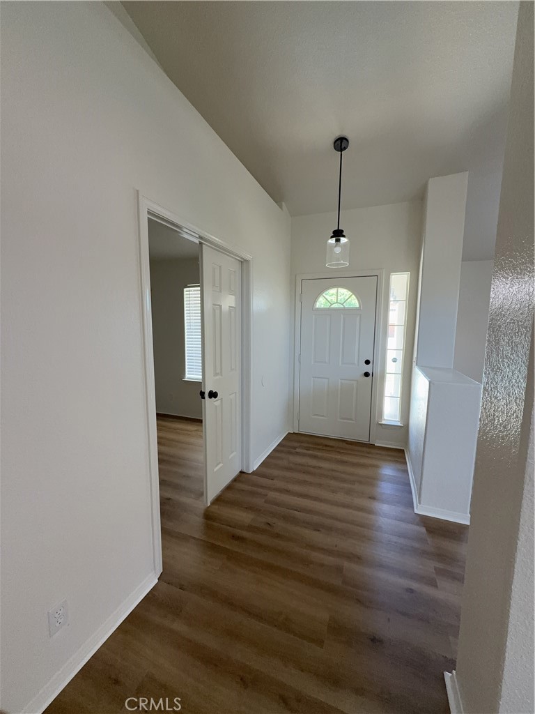 12590 Cobalt Road Victorville, CA 92392 - Photo 9 of 37 a view of a hallway with wooden floor and staircase
