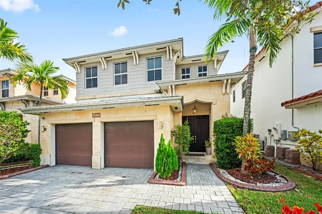 a front view of a building with a garden