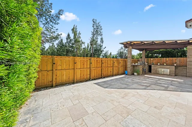 a kitchen with sink refrigerator and window