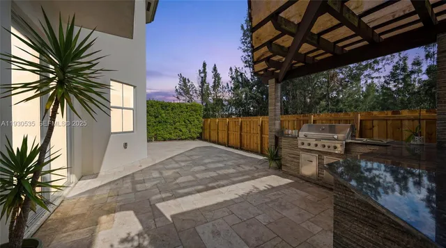 a backyard of a house with garden and outdoor seating