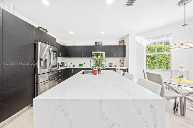 a bathroom with a granite countertop sink a toilet and shower