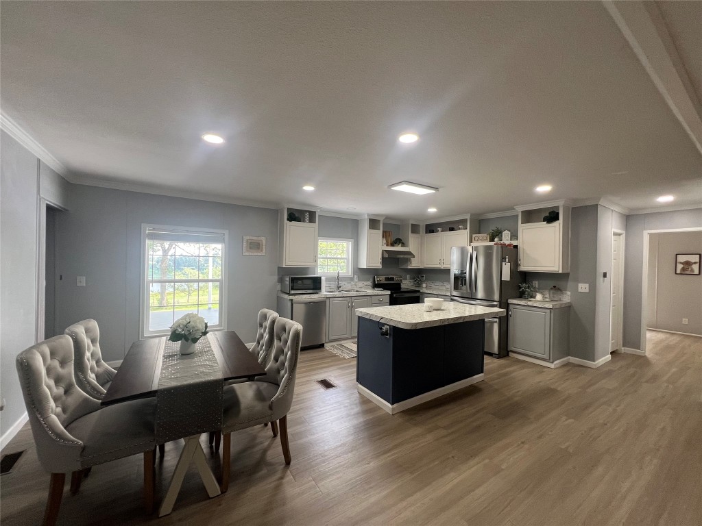 702 Paint Creek Road McDade, TX 78650 - Photo 24 of 40 a large open kitchen with a table and chairs