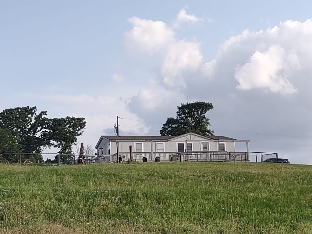 702 Paint Creek Road McDade, TX 78650 - Photo 30 of 40 a view of a big house with a big yard and large trees