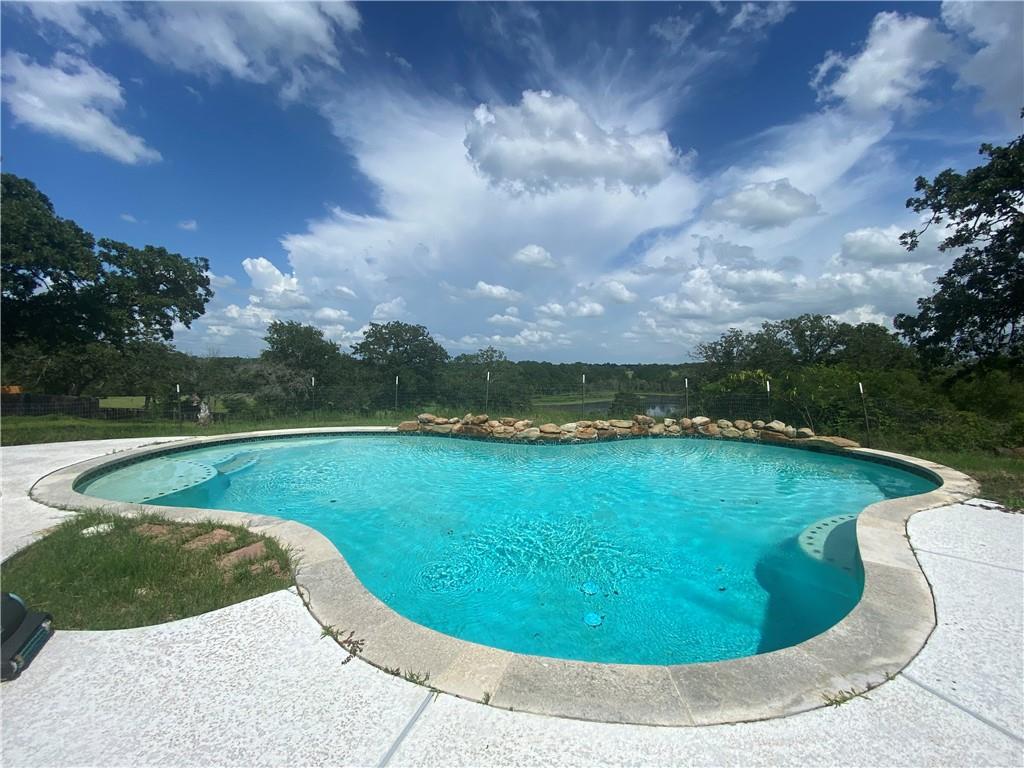 702 Paint Creek Road McDade, TX 78650 - Photo 32 of 40 a view of a swimming pool with a yard