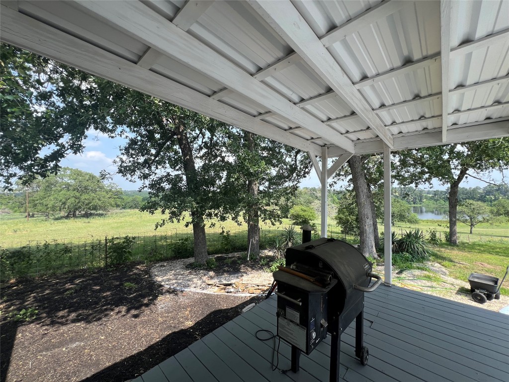 702 Paint Creek Road McDade, TX 78650 - Photo 6 of 40 a view of a patio with table and chairs potted plants with large tree