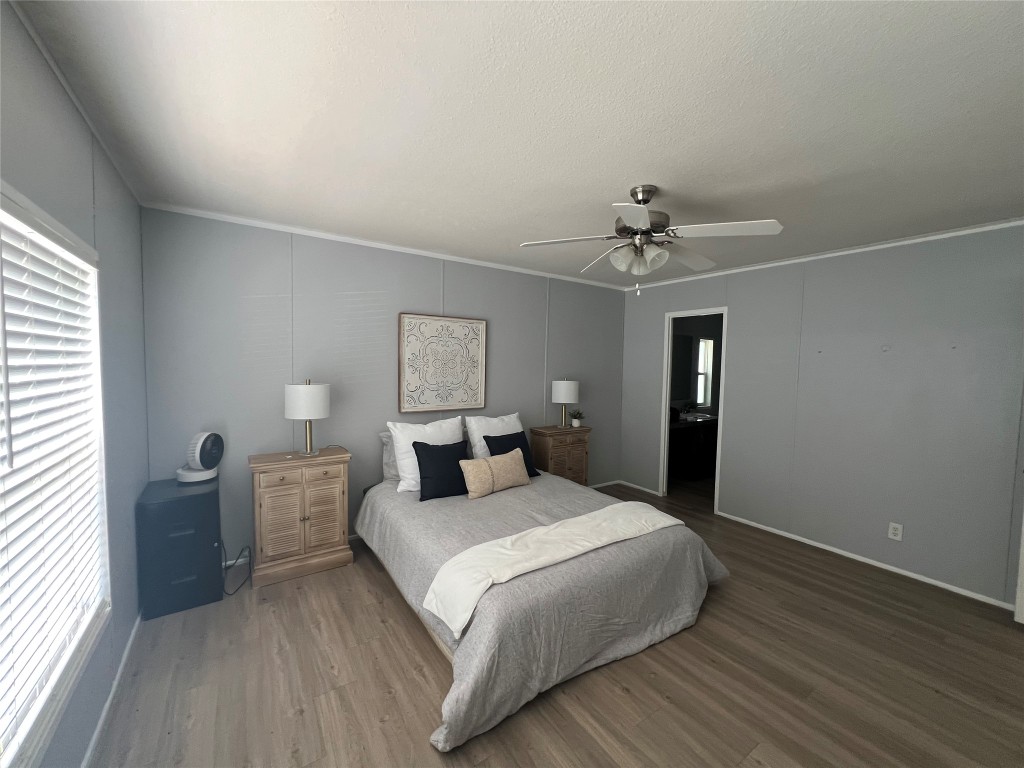 702 Paint Creek Road McDade, TX 78650 - Photo 7 of 40 a bedroom with a bed and a chandelier