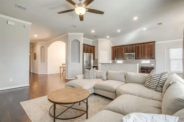 a kitchen with stainless steel appliances granite countertop a refrigerator and a stove top oven