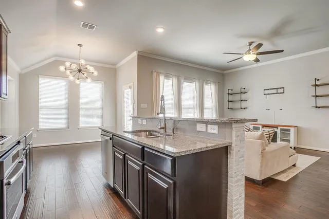 a kitchen with a sink stove and cabinets