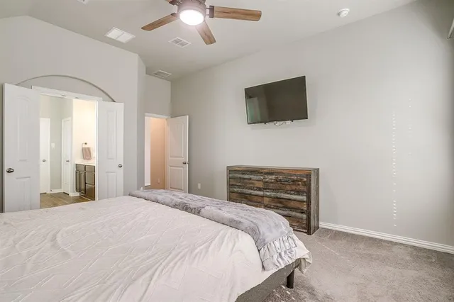 a bedroom with a bed and a flat screen tv