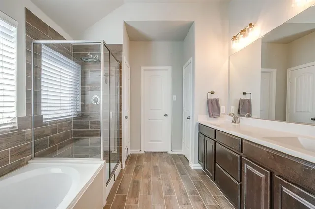 a bathroom with a sink a mirror and a bathtub