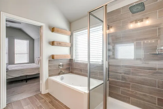 a bathroom with a tub a potted plant and a sink