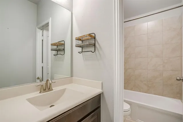 a room with a bed and a ceiling fan