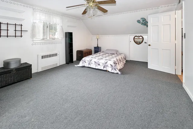 a bedroom with bed and a window