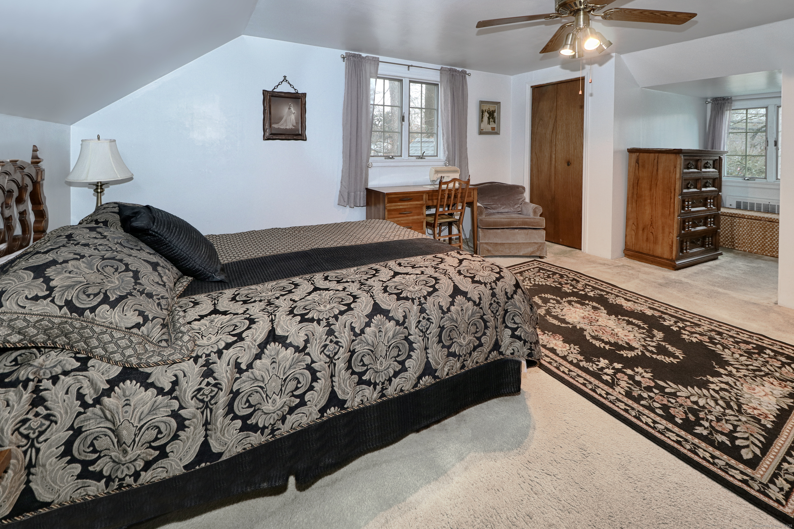 232 Church Hill Road Fairfield, CT 06825 - Photo 24 of 31 a bedroom with a bed and a chandelier