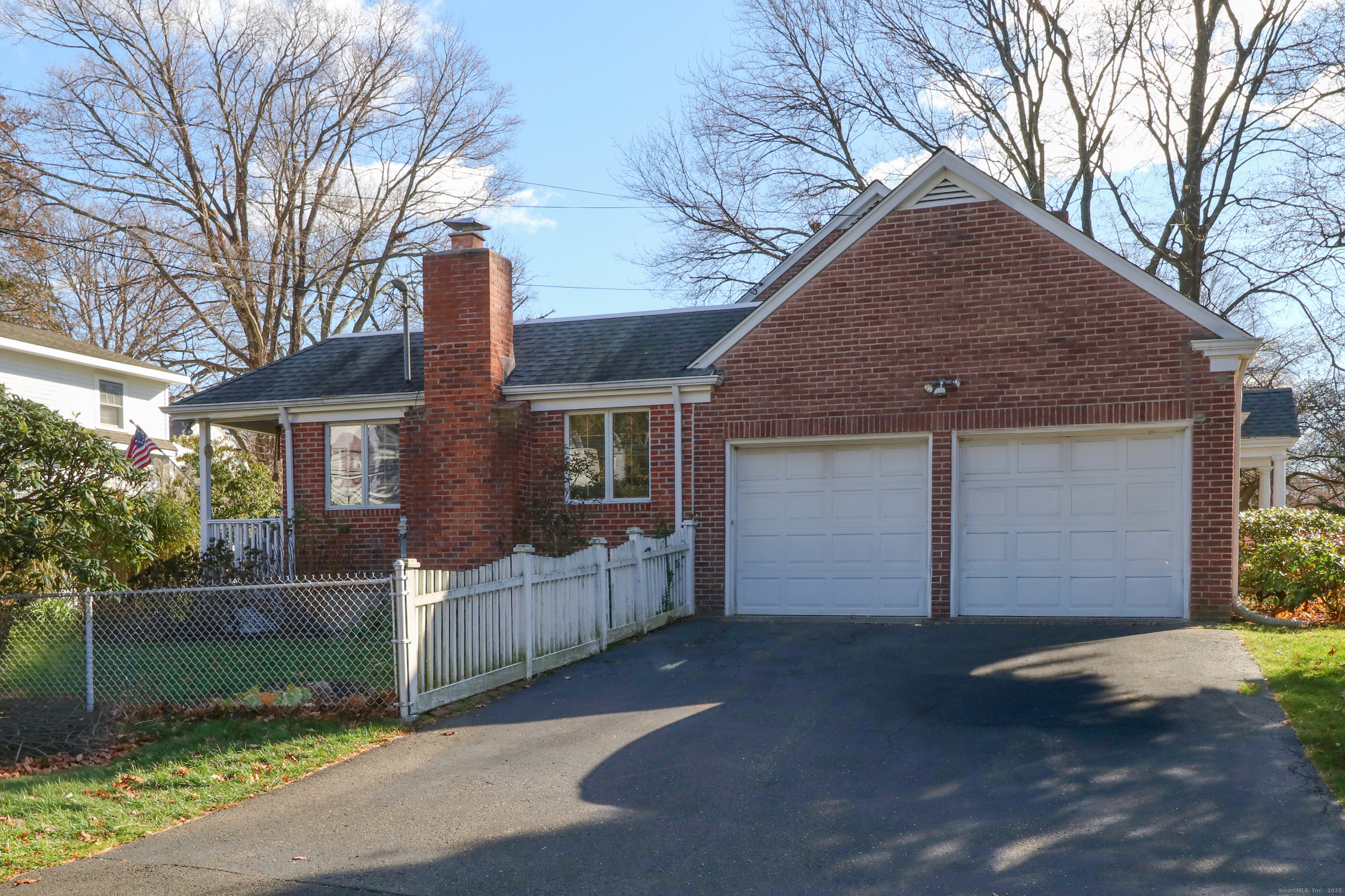 232 Church Hill Road Fairfield, CT 06825 - Photo 28 of 31 a front view of a house with a yard and garage