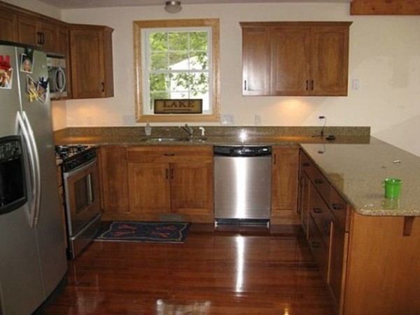 19 Sandy Beach Road Holland, MA 01521 - Photo 3 of 28 a kitchen with stainless steel appliances granite countertop a sink stove and refrigerator