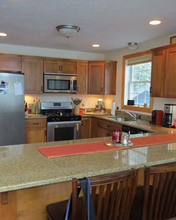 19 Sandy Beach Road Holland, MA 01521 - Photo 10 of 28 a kitchen with stainless steel appliances granite countertop a sink a stove and a refrigerator