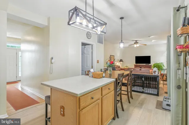 a view of a dining room with furniture and a chandelier