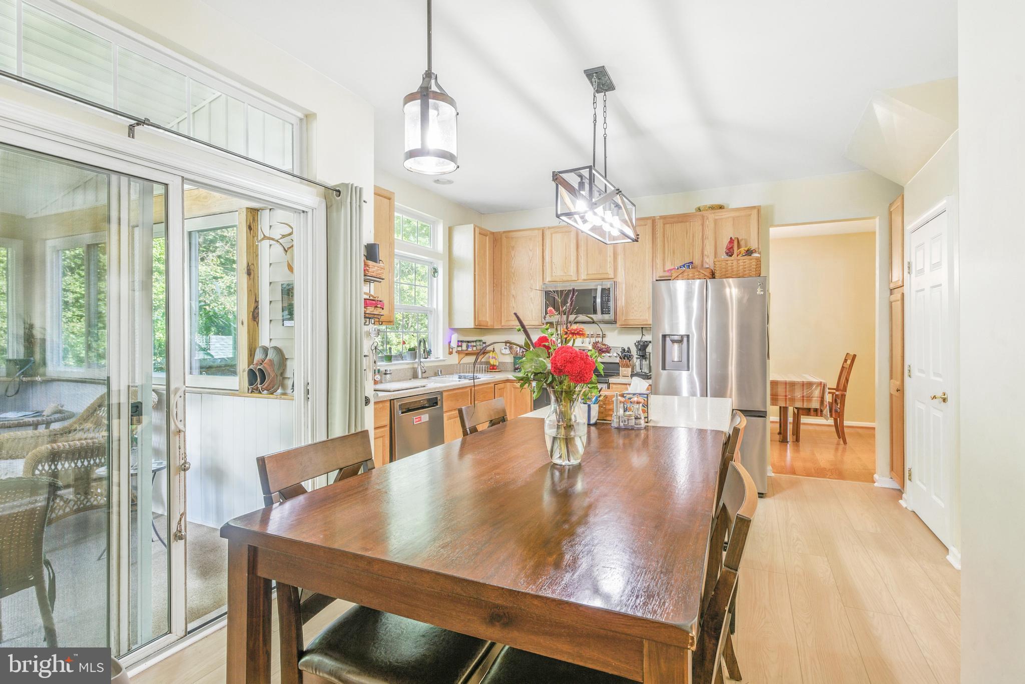 463 Preakness Run Newark, DE 19702 - Photo 13 of 32 a view of a dining room and livingroom with furniture wooden floor a chandelier