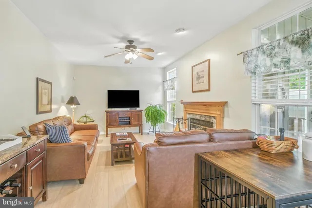 a living room with fireplace furniture and a flat screen tv