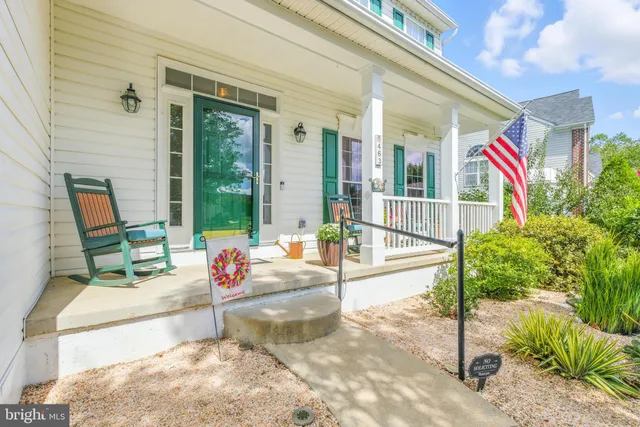 a living room filled with furniture and a potted plant