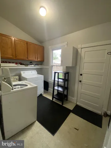 a view of kitchen with refrigerator and cabinets