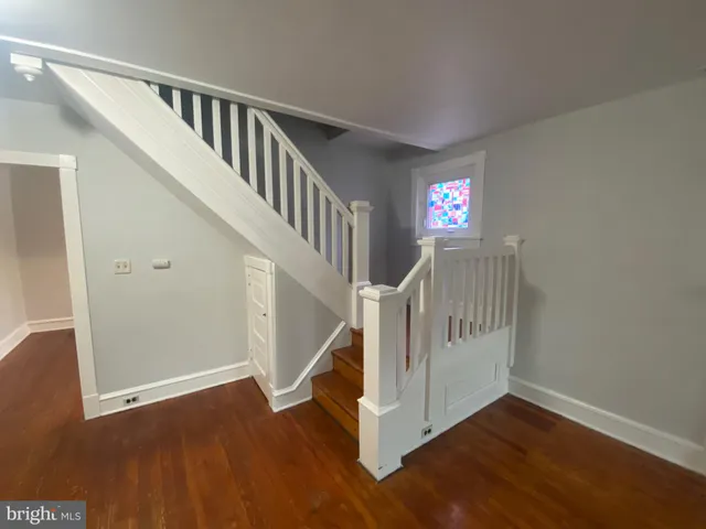 a view of entryway with wooden floor and stairs