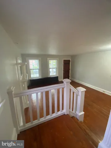 a view of wooden floor and windows in a room