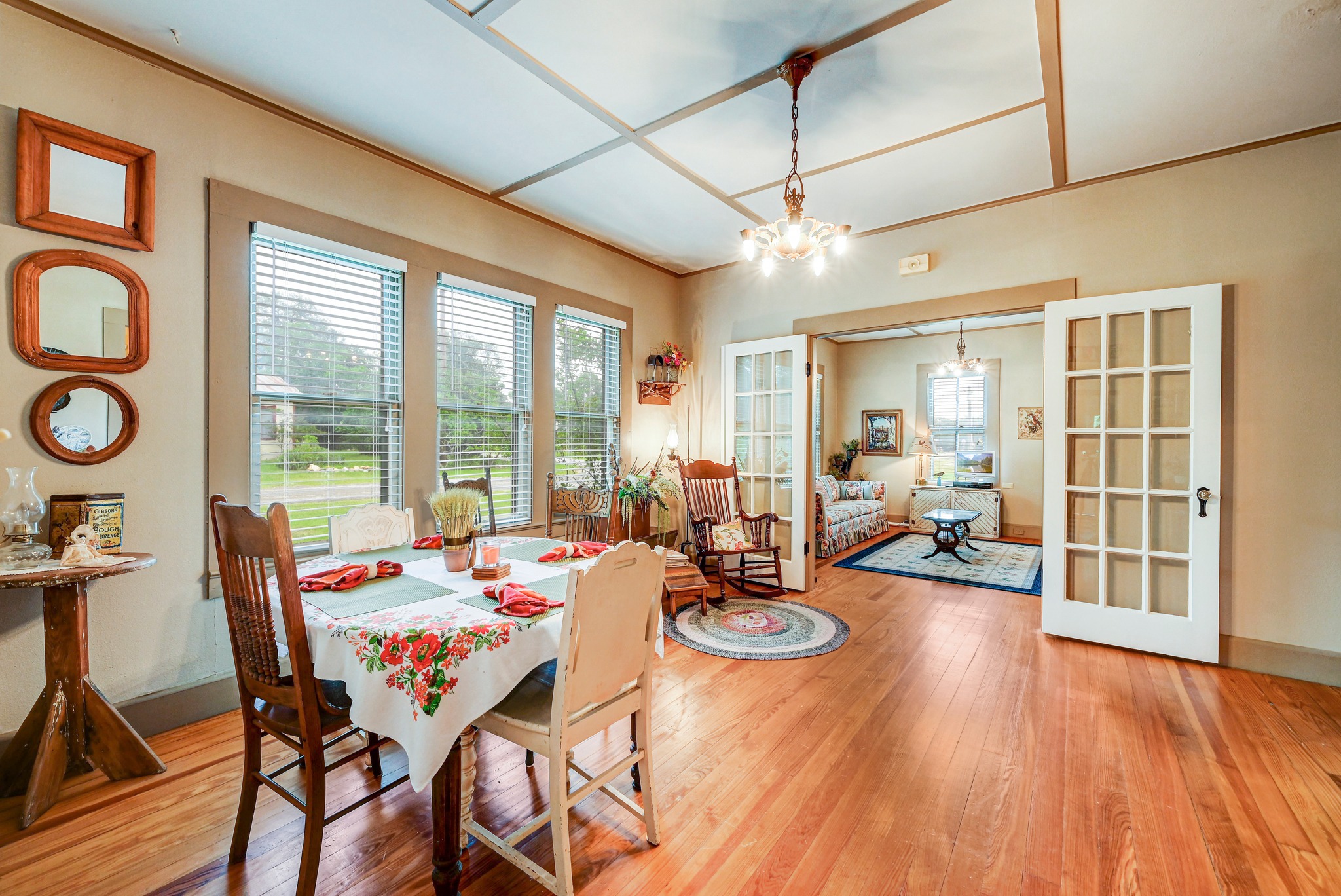 719 Elm Street Blanco, TX 78606 - Photo 11 of 25 Hardwood flooring defines this space with coffered ceilings and a decorative chandelier