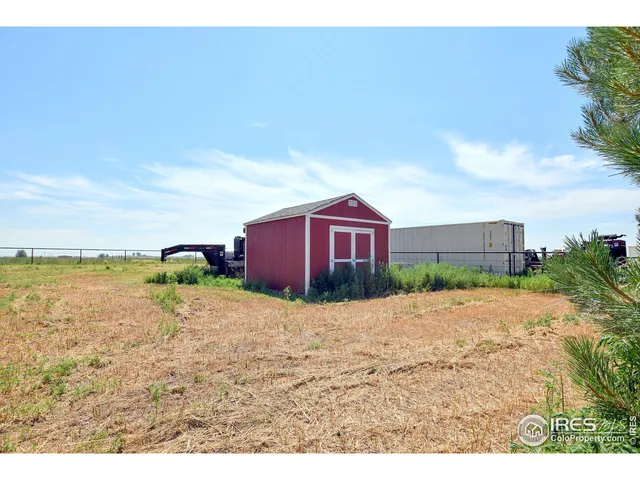 a view of a dry yard with a house