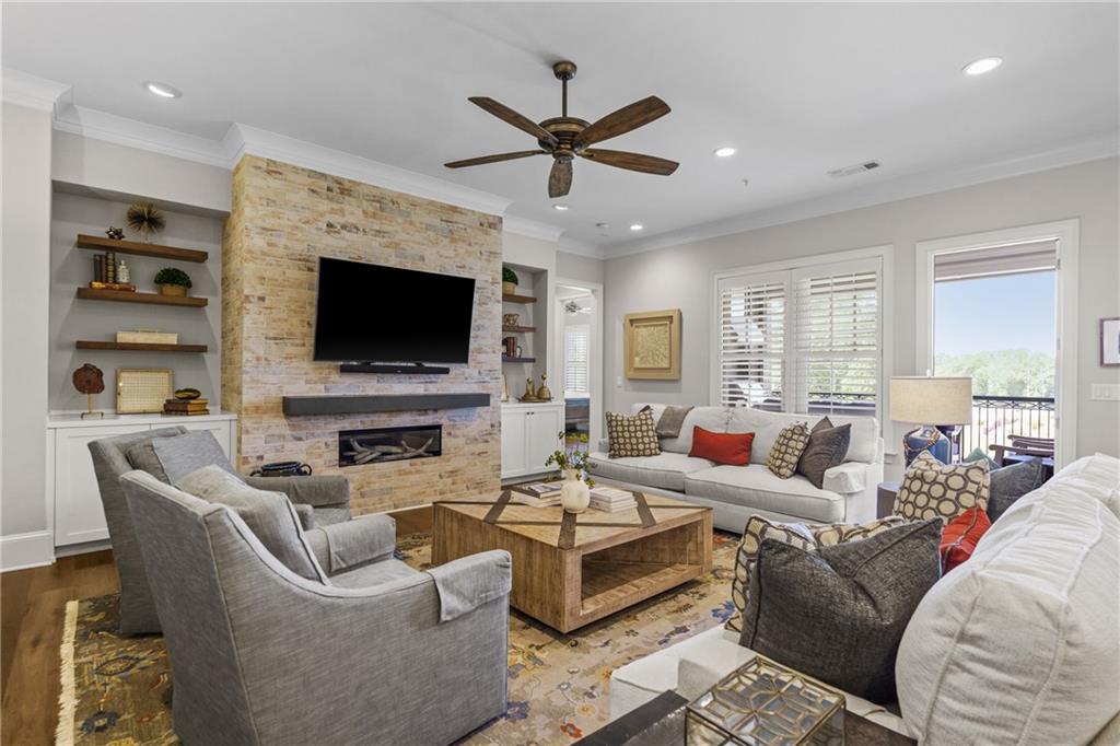 50 Canton Street, Unit 307 Alpharetta, GA 30009 - Photo 15 of 56 a living room with furniture a fireplace and a flat screen tv