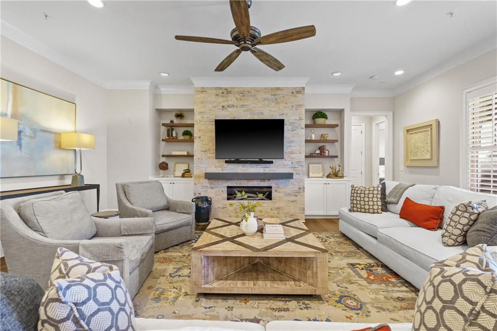 50 Canton Street, Unit 307 Alpharetta, GA 30009 - Photo 16 of 56 a living room with furniture a fireplace and a flat screen tv