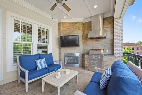 a view of outdoor living space with furniture and wooden floor