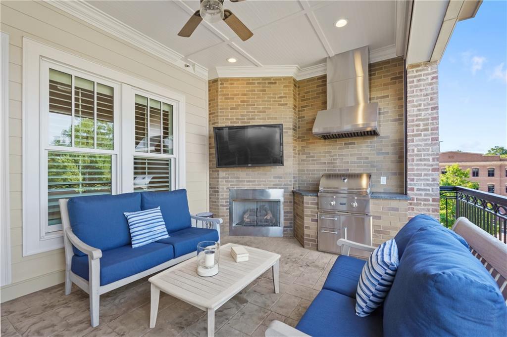 50 Canton Street, Unit 307 Alpharetta, GA 30009 - Photo 19 of 56 a living room with fireplace furniture and a flat screen tv