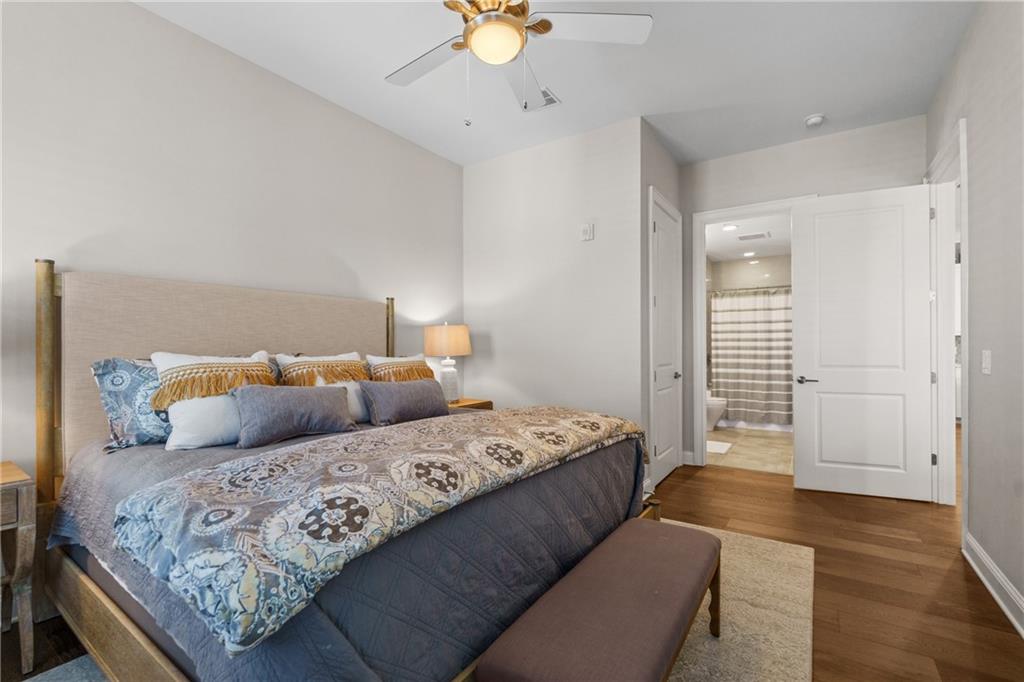 50 Canton Street, Unit 307 Alpharetta, GA 30009 - Photo 28 of 56 a bedroom with a bed and a chandelier