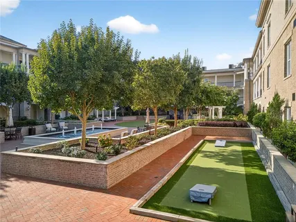 a kitchen with stainless steel appliances kitchen island granite countertop a table and chairs in it