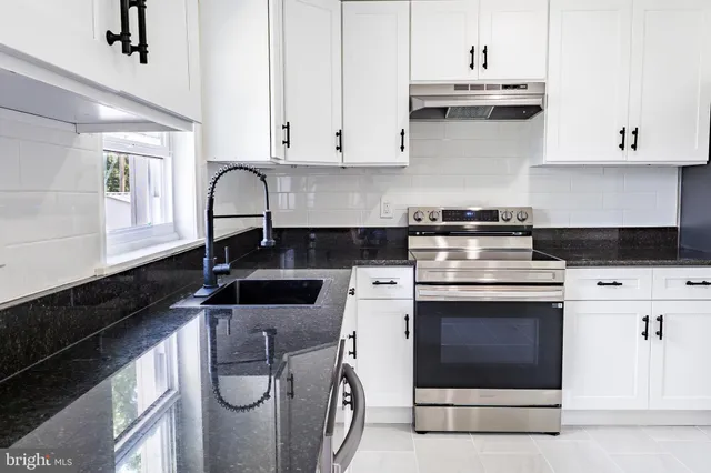 an empty room with wooden floor and a fireplace