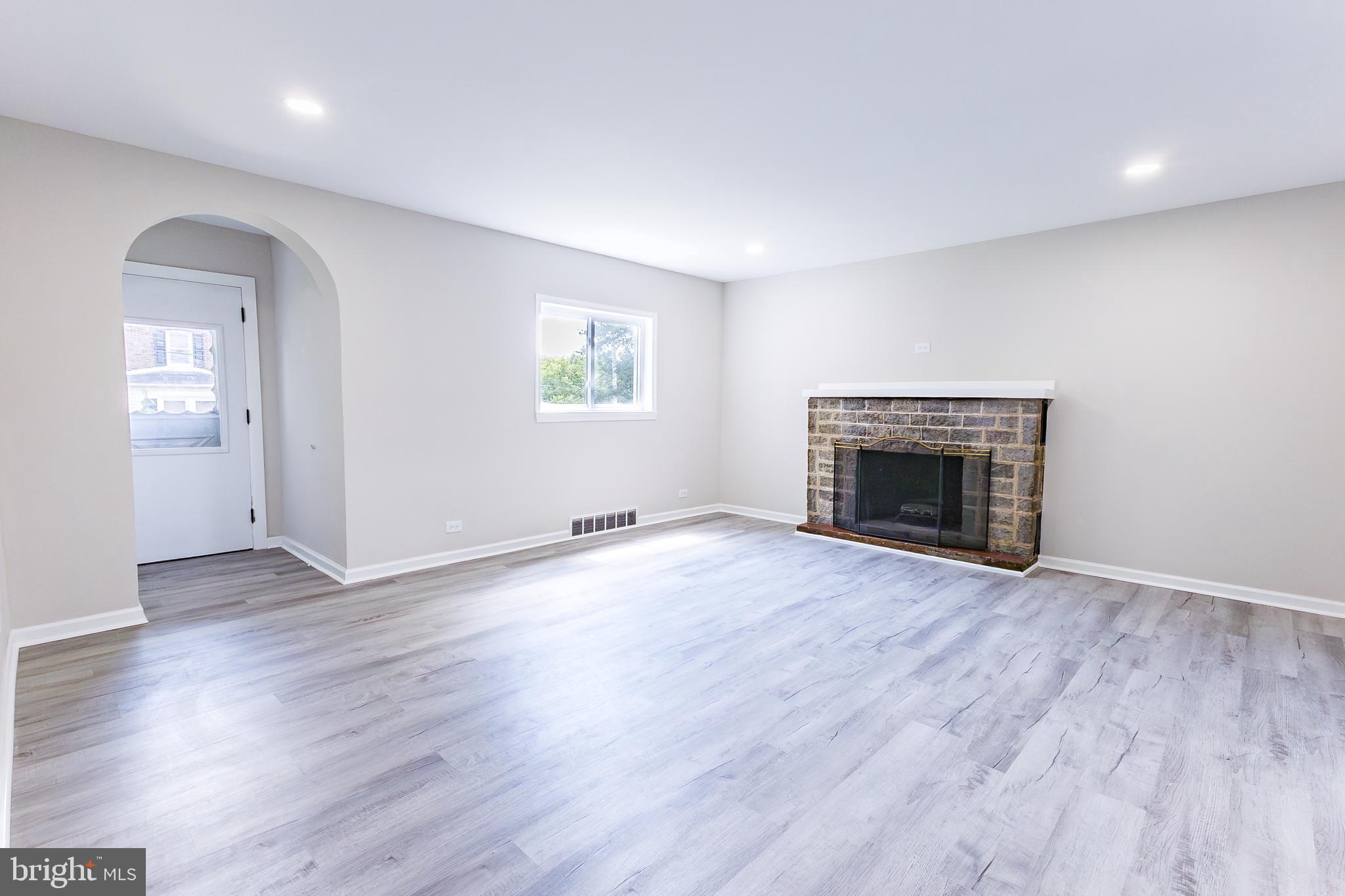 Elliot Avenue Bethlehem, PA 18018 - Photo 18 of 39 an empty room with wooden floor and a fireplace