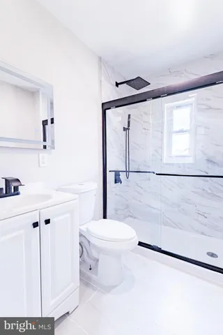 a bathroom with a sink a toilet a mirror and vanity