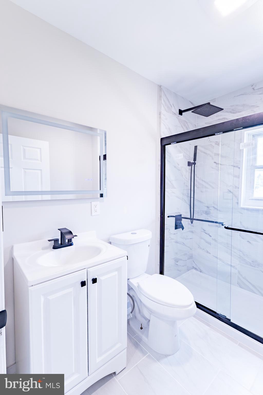 Elliot Avenue Bethlehem, PA 18018 - Photo 26 of 39 a bathroom with a sink a toilet a mirror and vanity