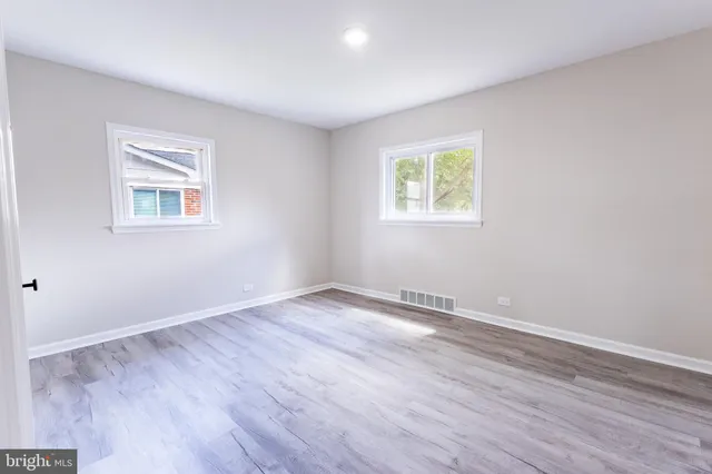 a view of an empty room with wooden floor
