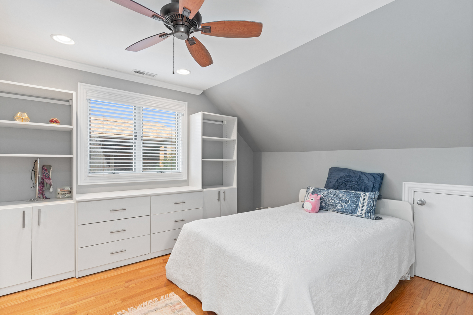 424 Willow Street Itasca, IL 60143 - Photo 20 of 47 a bedroom with a large bed and a chandelier