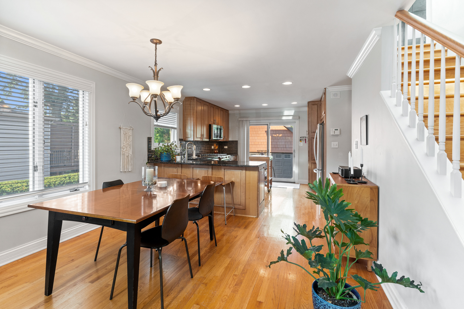 424 Willow Street Itasca, IL 60143 - Photo 7 of 47 a room with stainless steel appliances kitchen island granite countertop furniture and a chandelier