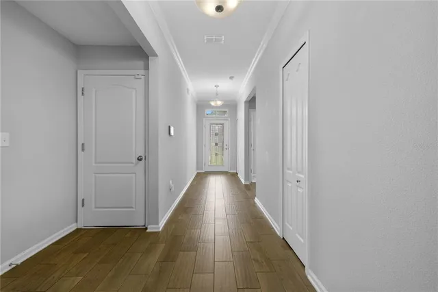 a view of a hallway with wooden floor