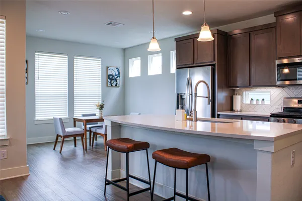 a kitchen with stainless steel appliances a stove a microwave and cabinets