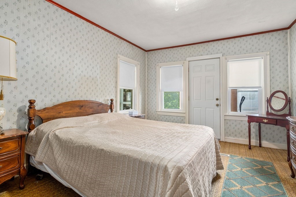 41 Berkeley Street Watertown, MA 02472 - Photo 12 of 14 a bedroom with a bed a table and chair