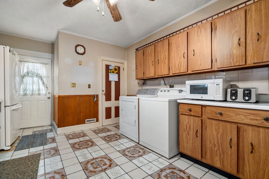 41 Berkeley Street Watertown, MA 02472 - Photo 4 of 14 a utility room with cabinets washer and dryer