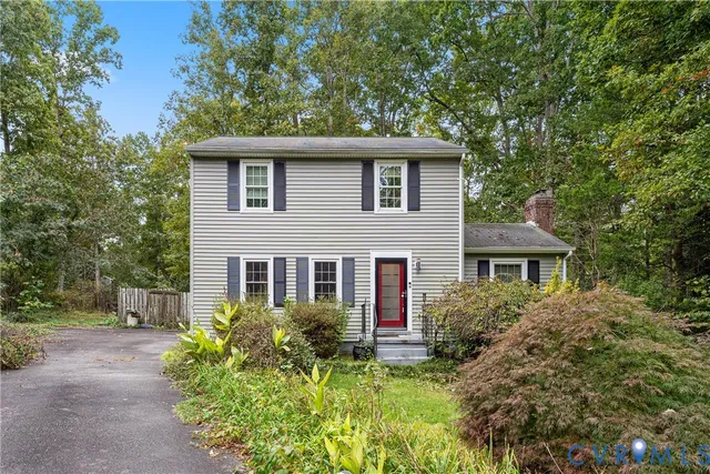 a view of a house with a yard and plants